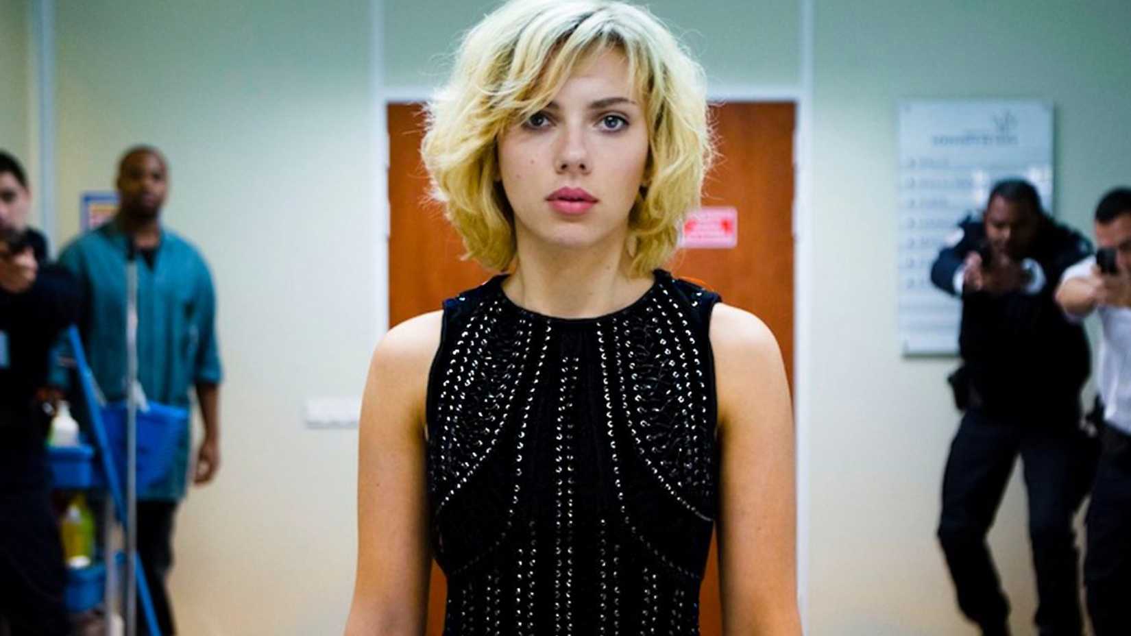 Scarlett Johansson in Lucy wearing a black dress in a hospital