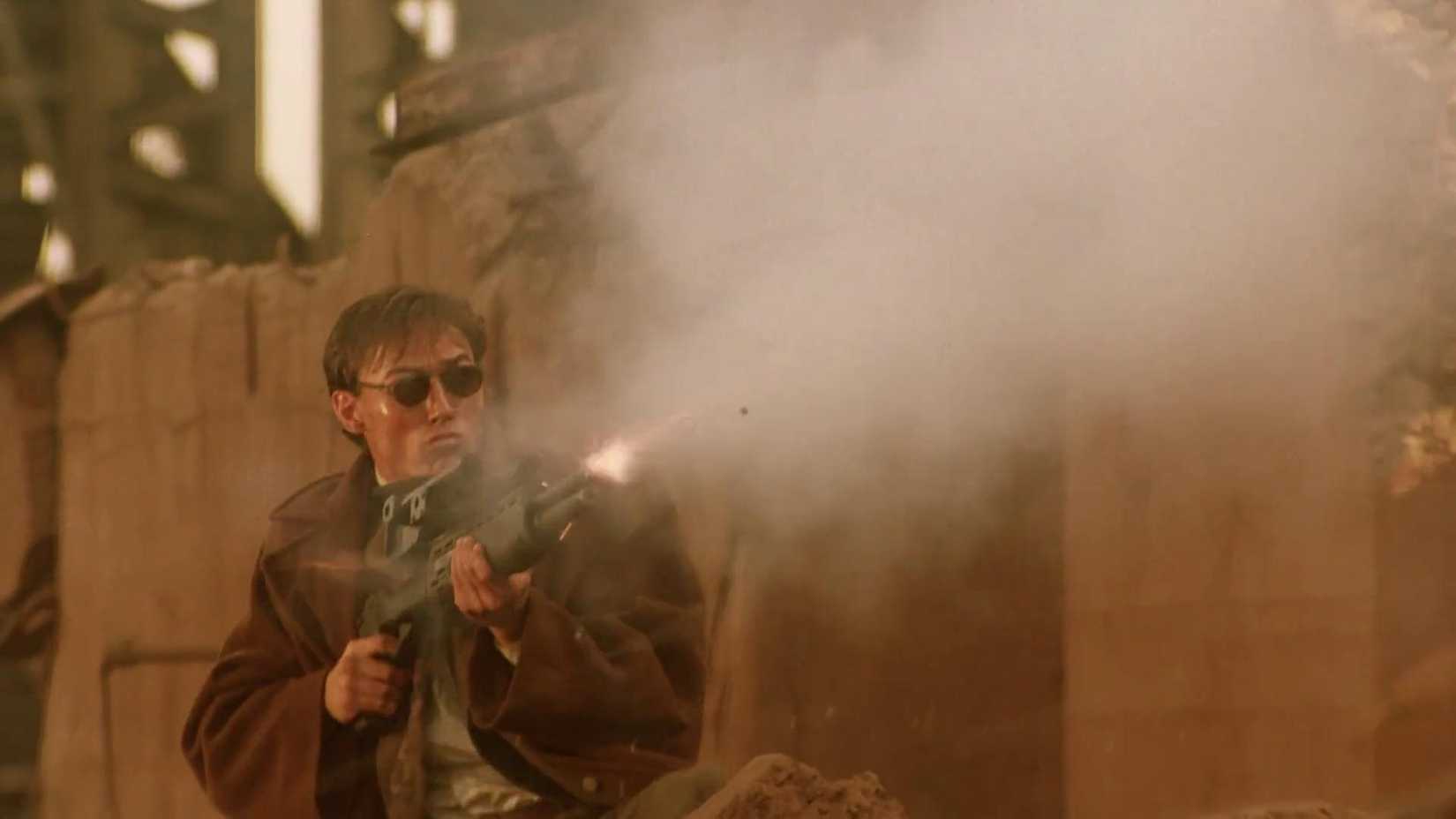 Man shooting a gun in the sci-fi movie Nemesis (1992)