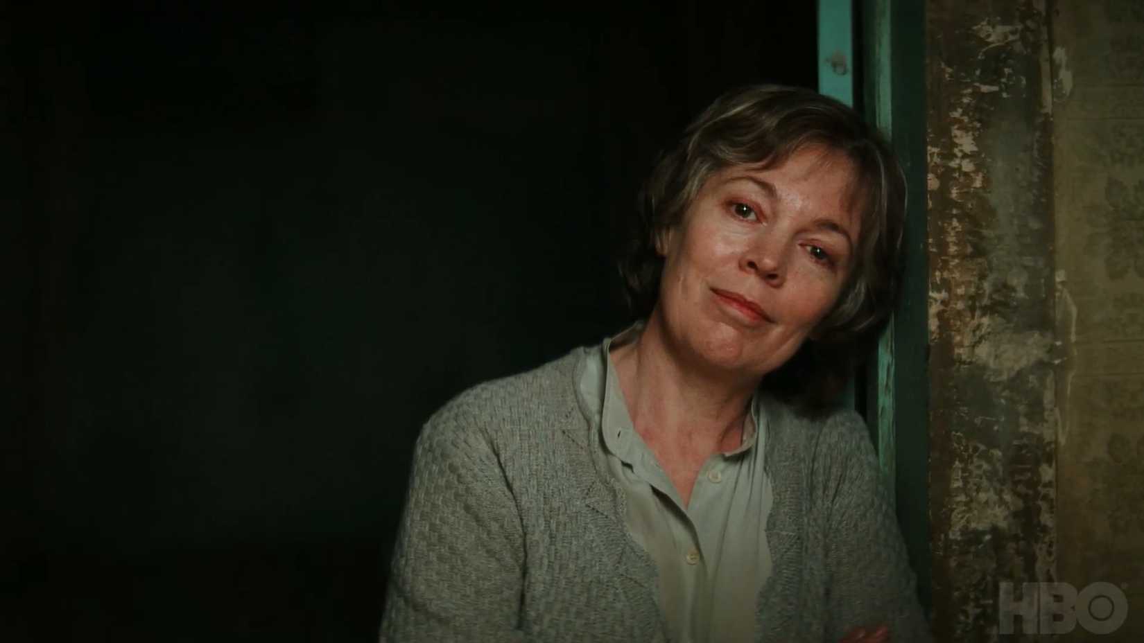 Olivia Colman as Susan Edwards resting her head against the wall in Landscapers