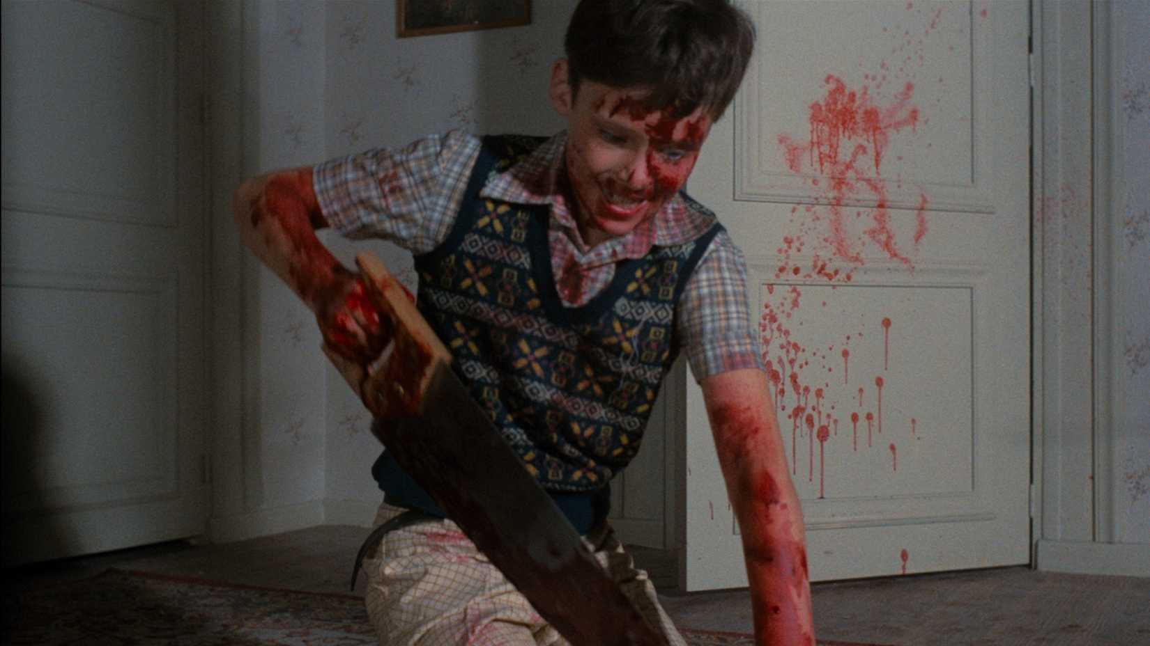 a boy uses a saw to dismember a body in the film Pieces