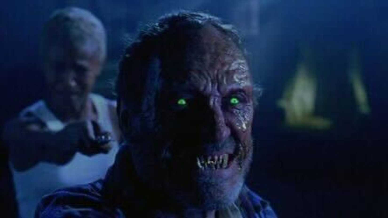 A monster with green glowing eyes in Tales From the Crypt Demon Knight