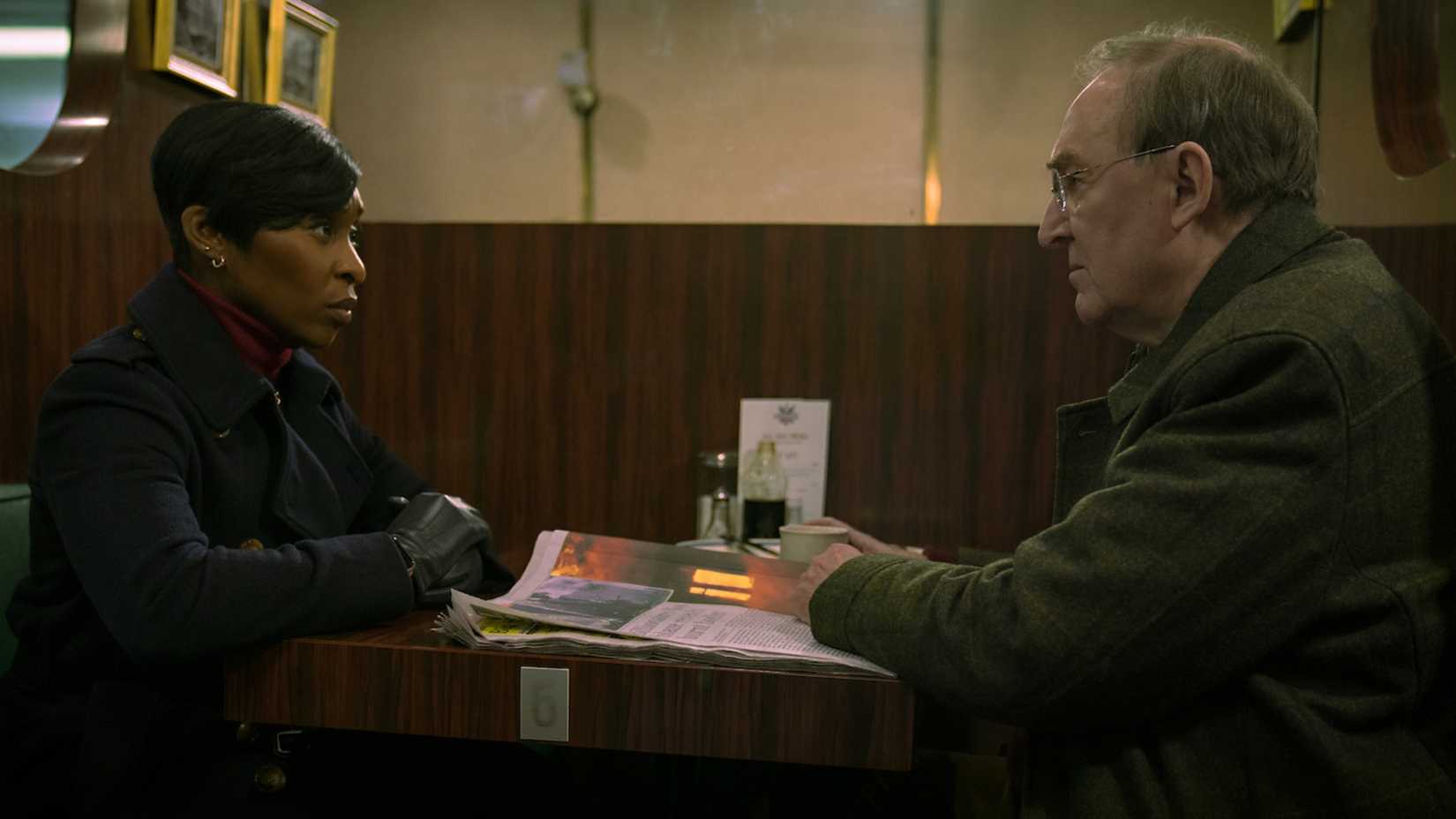 A woman & man have a conversation in Luther: The Fallen Sun