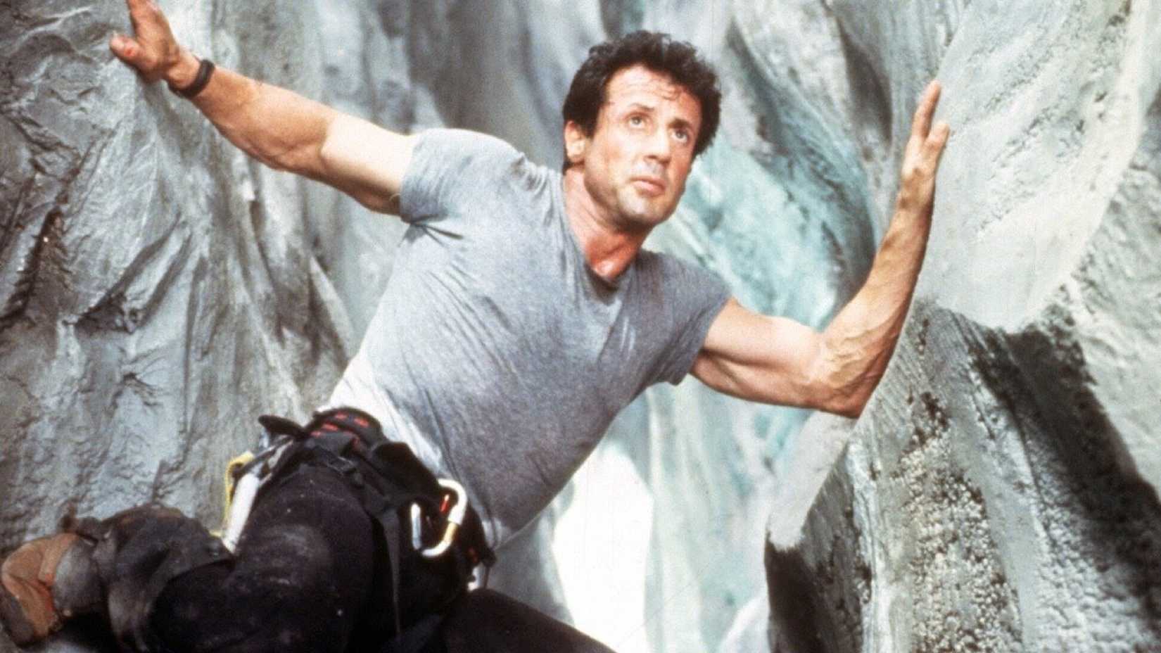 Sylvester Stallone pressed up against two rocks in Cliffhanger
