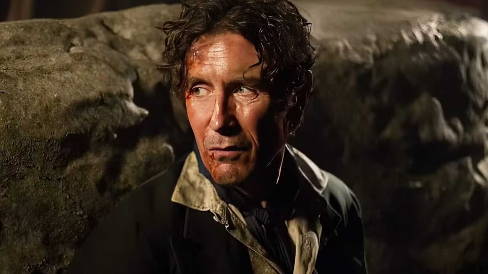 Paul McGann as the Eighth Doctor, covered in blood and staring off at something, in the Doctor Who minisode 