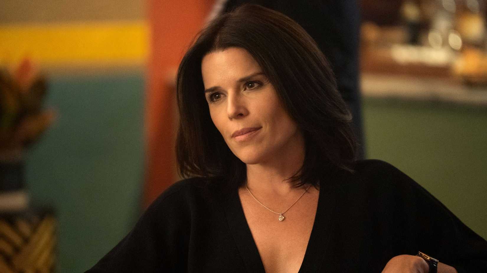 Neve Campbell in a black top as Maggie McPherson in The Lincoln Lawyer