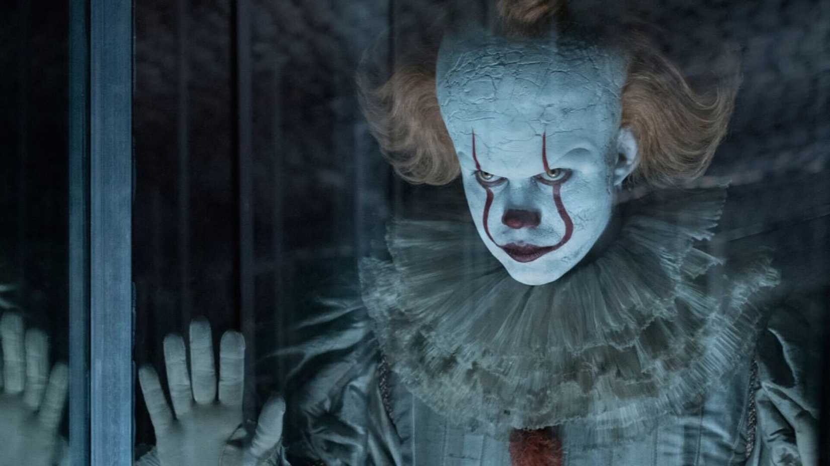 Pennywise looking through glass in It Chapter Two