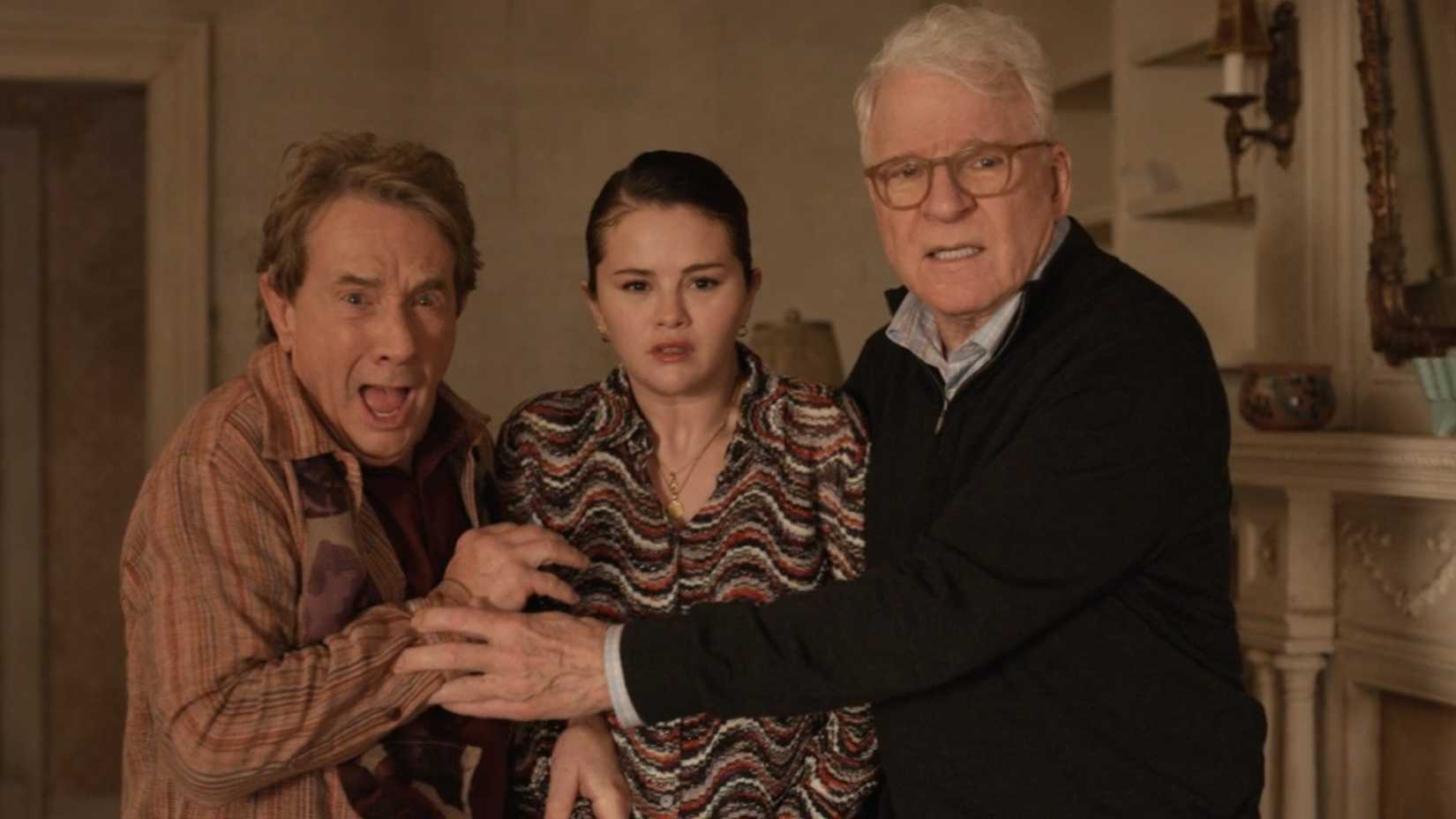 Oliver, Mabel, and Charles cowering in fear in Only Murders in the Building