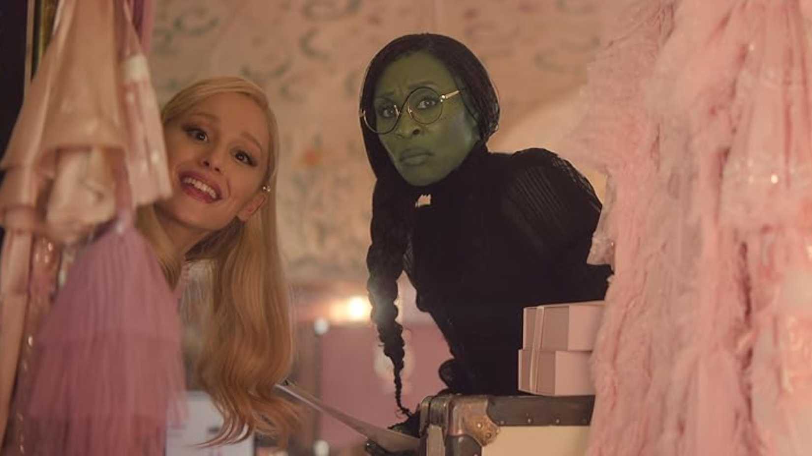 Ariana Grande and Cynthia Erivo look in the mirror in Wicked