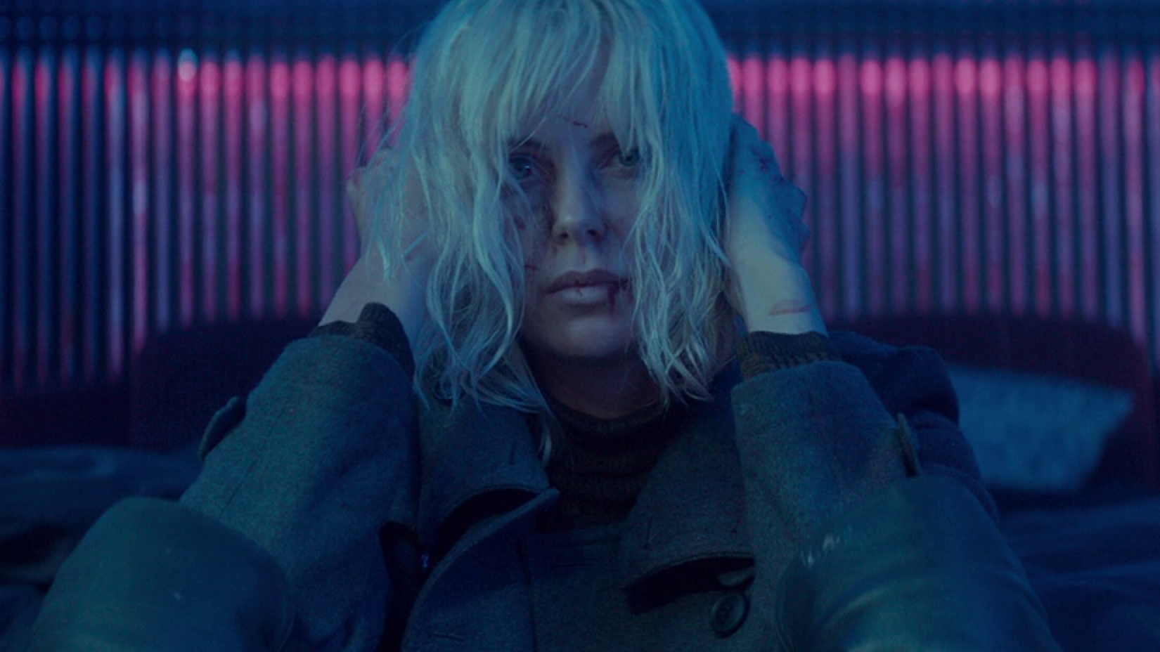Charlize Theron with head in hands in Atomic Blonde