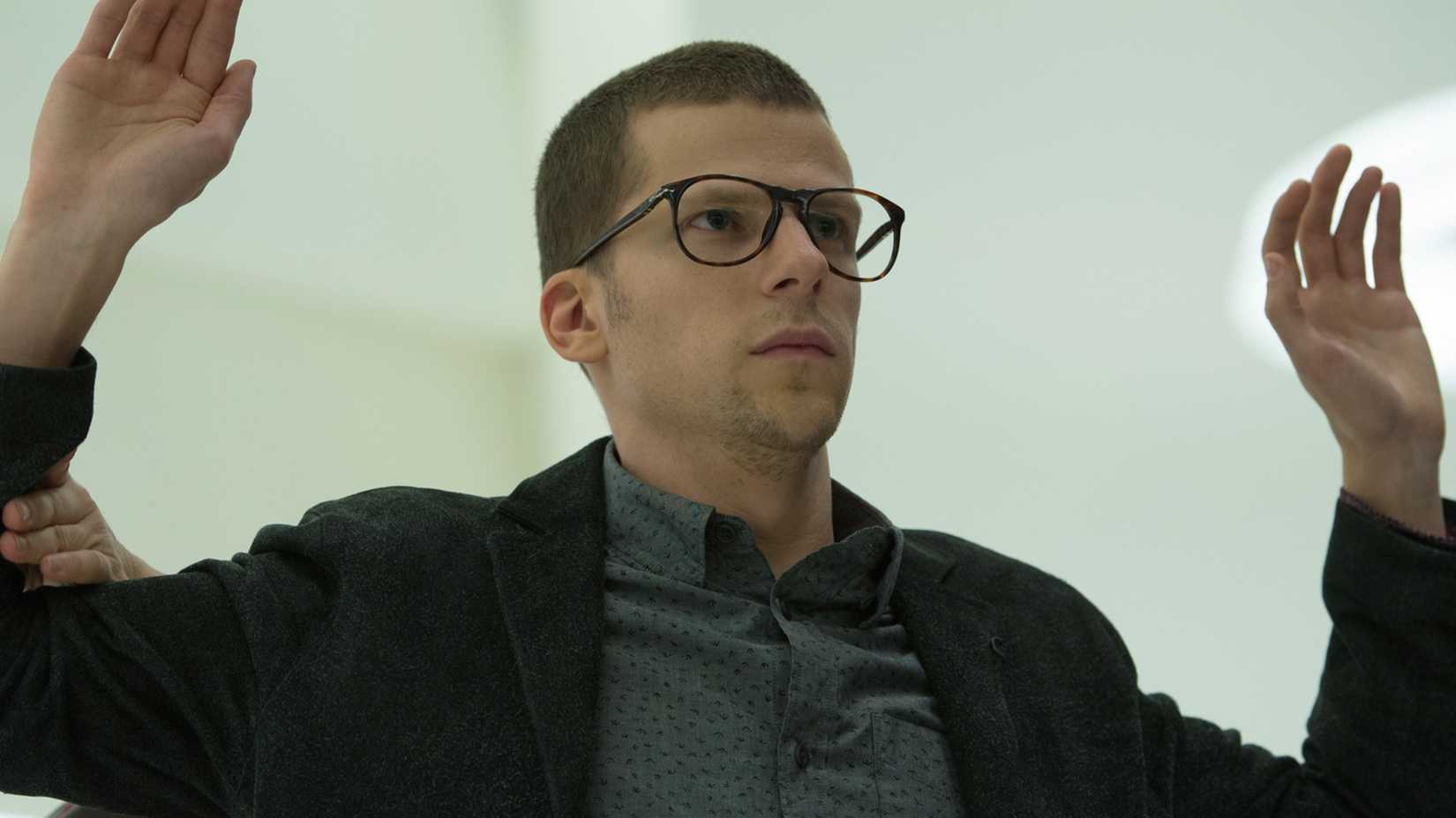 Jesse Eisenberg in Now You See Me 2 holding his hands up
