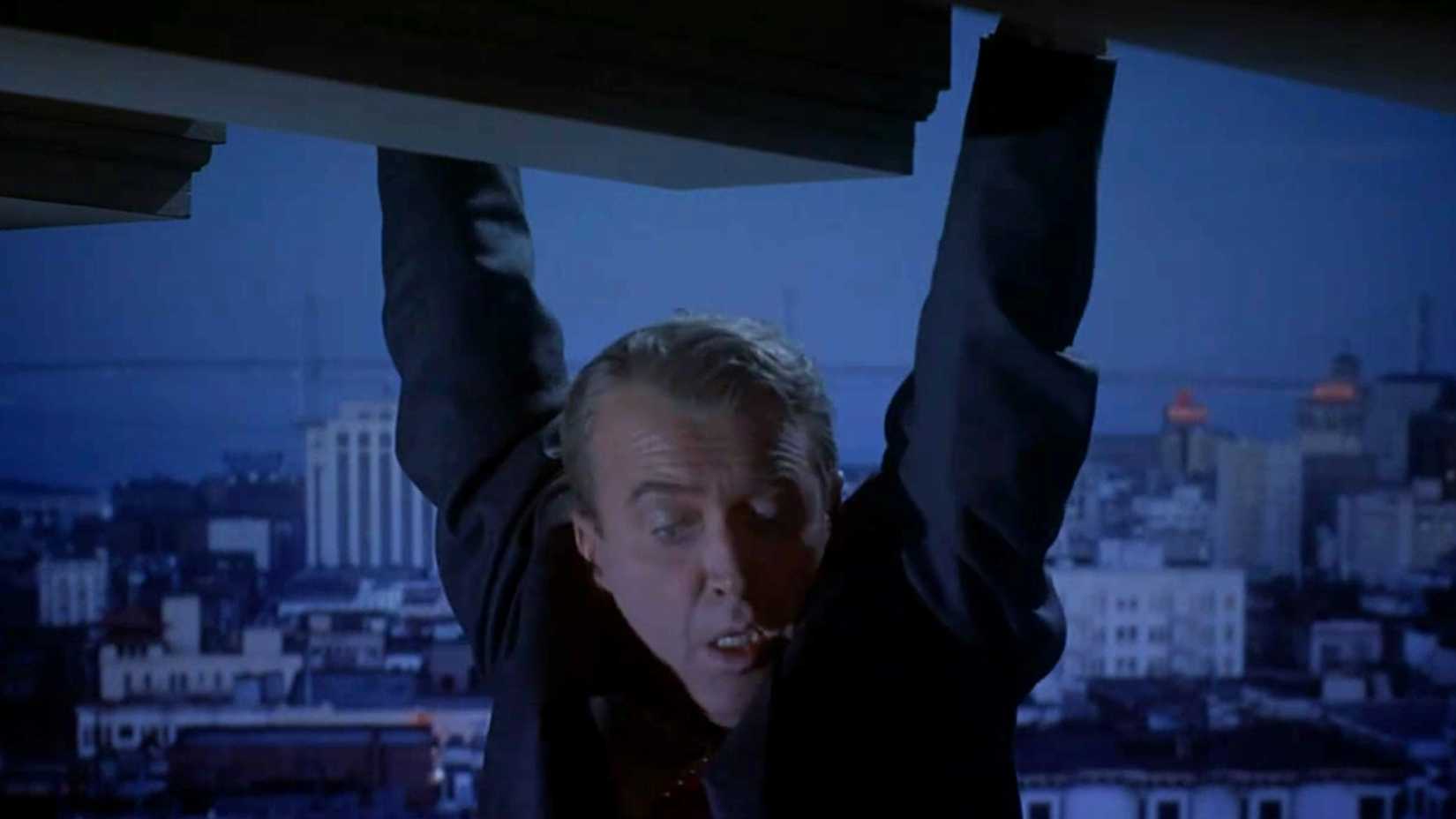 Jimmy Stewart hanging from a building and looking down in the movie Vertigo