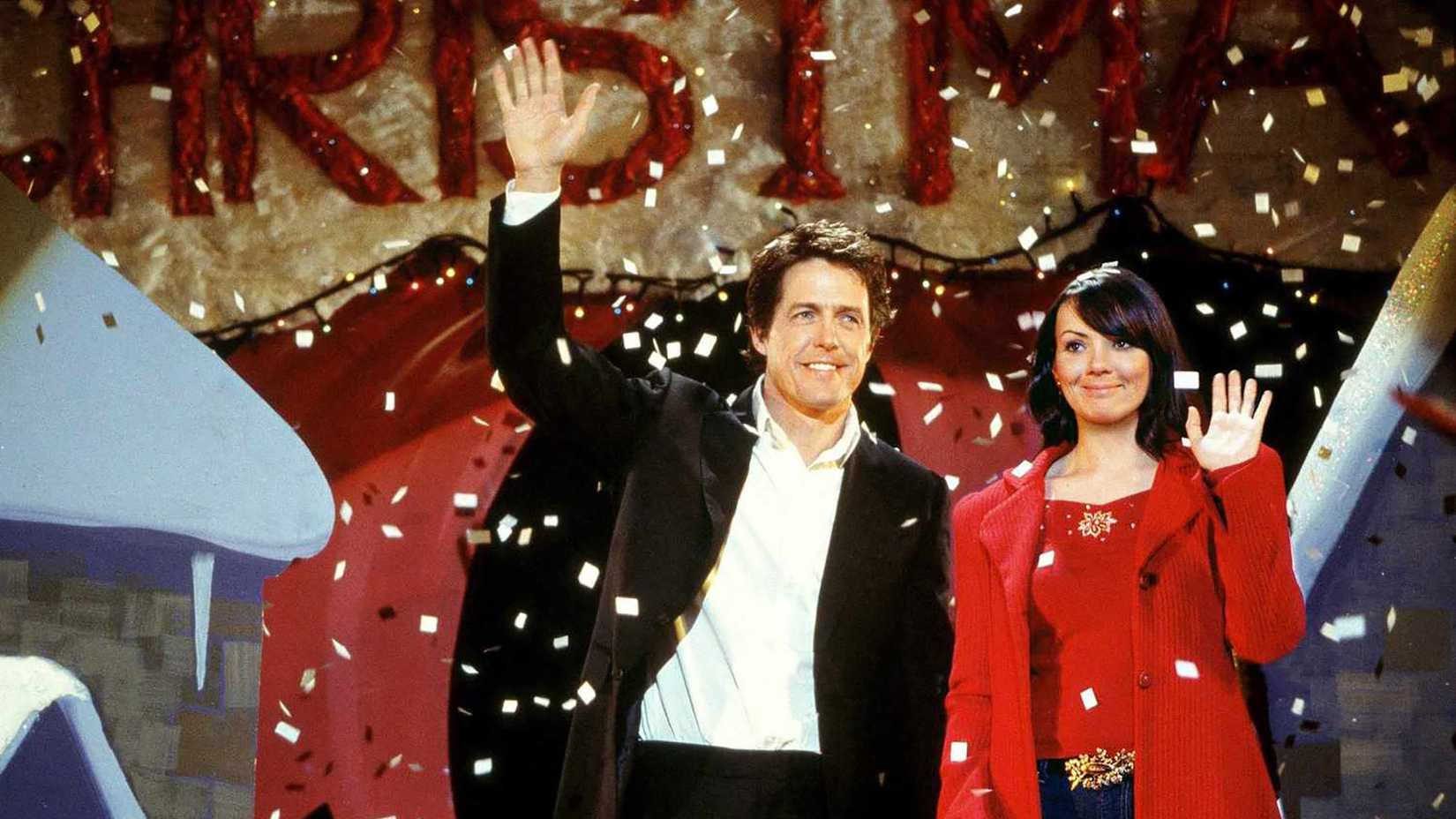 David and Natalie standing on a stage with confetti dropping over them in Love Actually
