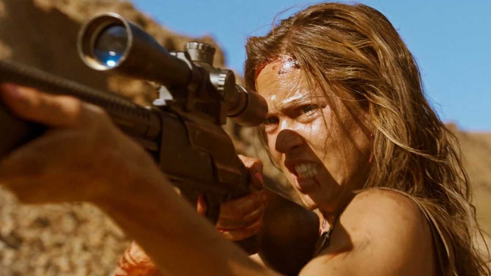 Jen (Matilda Lutz) wields a gun in Revenge (2017)