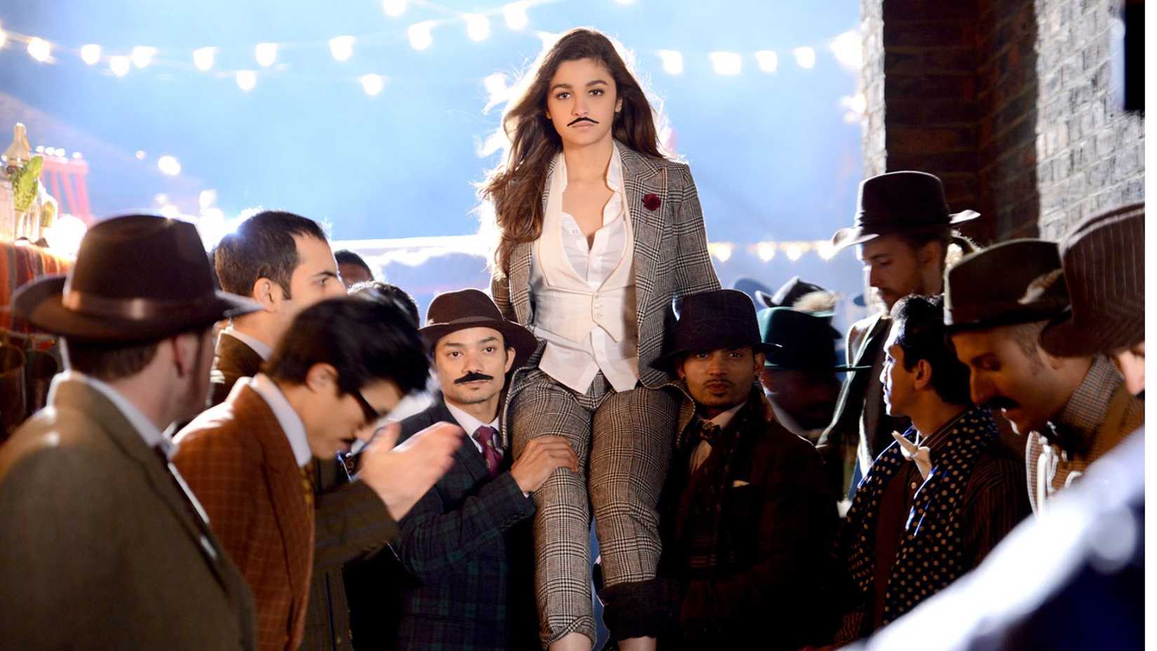 Alia Bhatt wearing a moustache carried by a crowd in Shaandaar (2015)