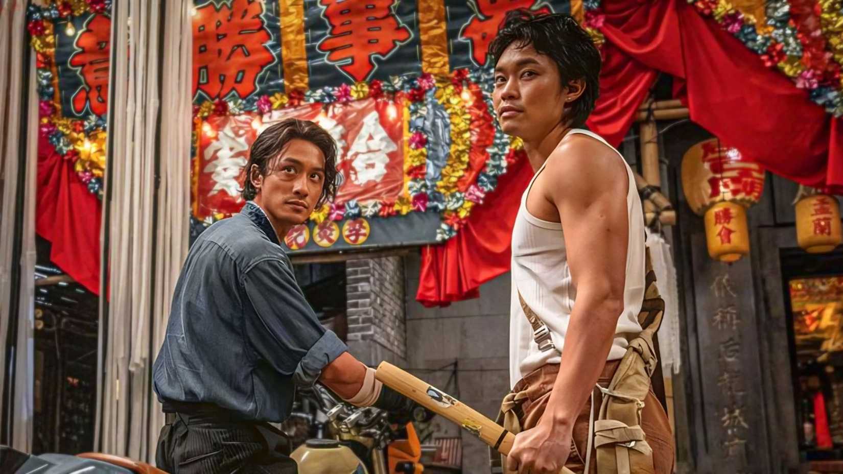 Two men looking back, one with a baton, one on a motorcycle in Twilight of the Warriors: Walled In (2024)