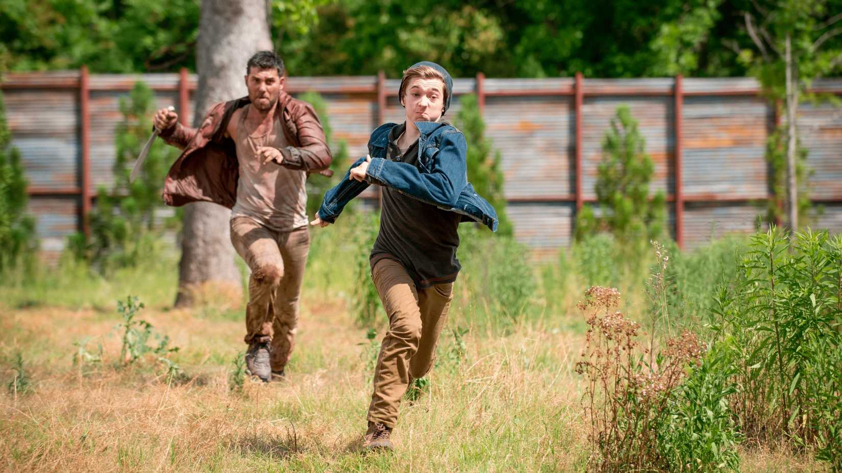 A man chases a boy in The Walking Dead