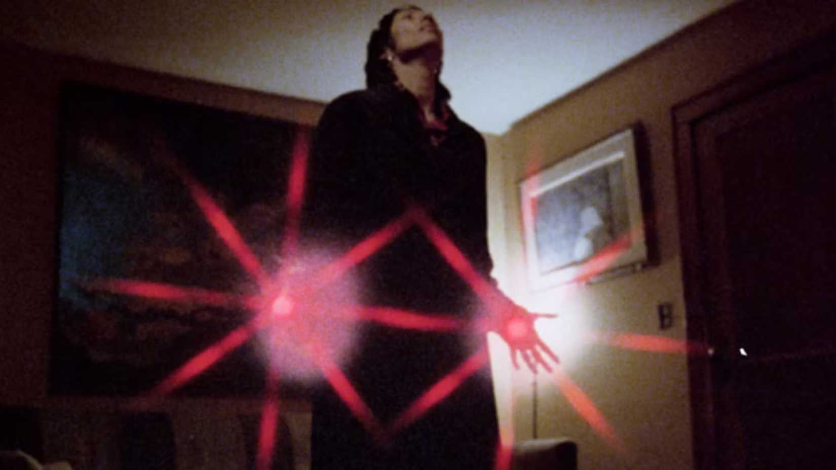 A man summons red energy in his hands in Bloodbeat