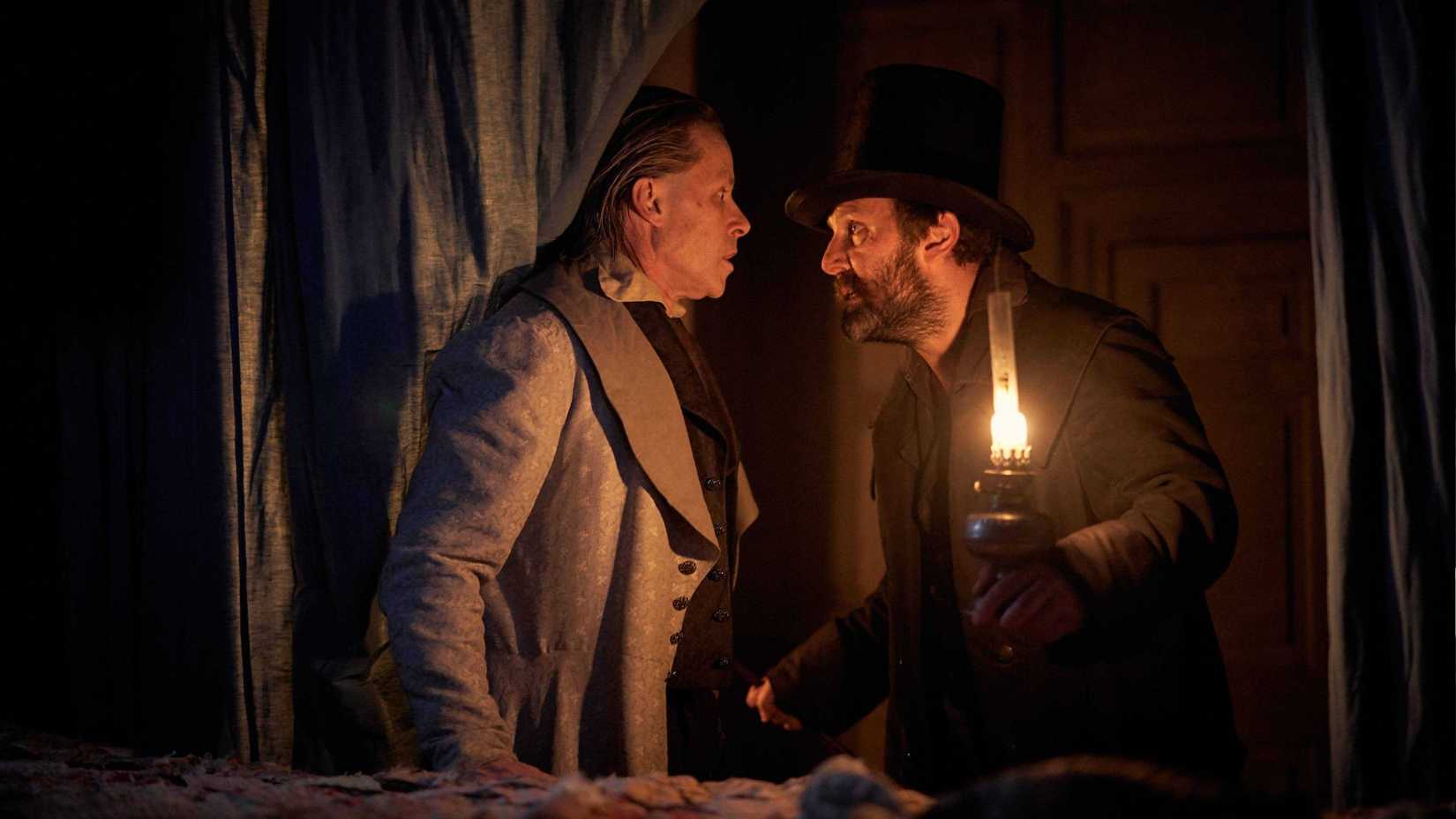 Guy Pearce scared by a man with a lamp in A Christmas Carol (2019)