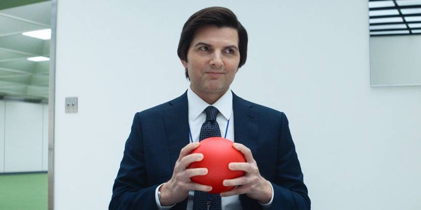 Adam Scott's Mark Scout holding a red ball during an office exercise in Severance