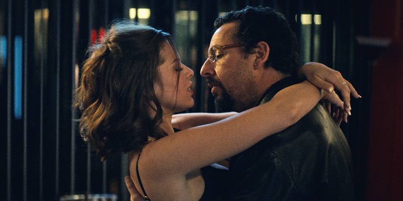 Julia Fox holds Adam Sandler in Uncut Gems