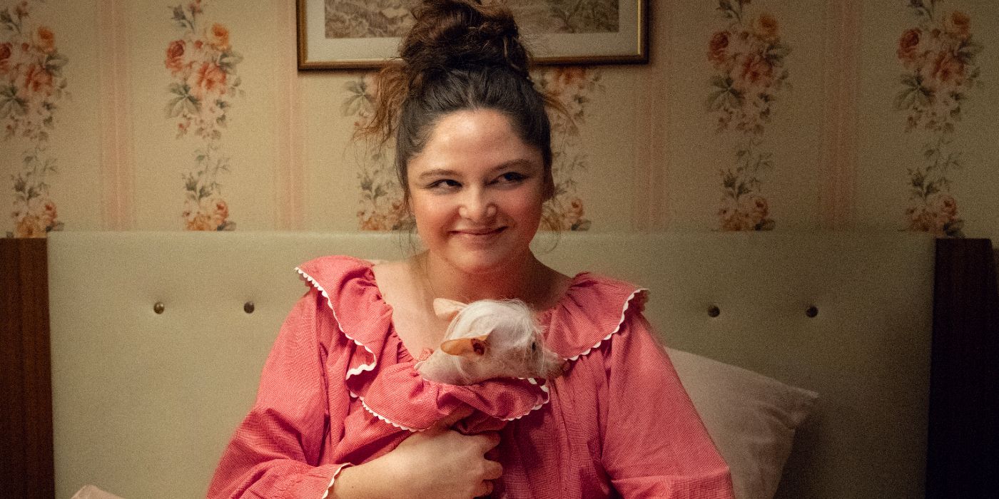 Meg Stalter in Too Much holding a dog