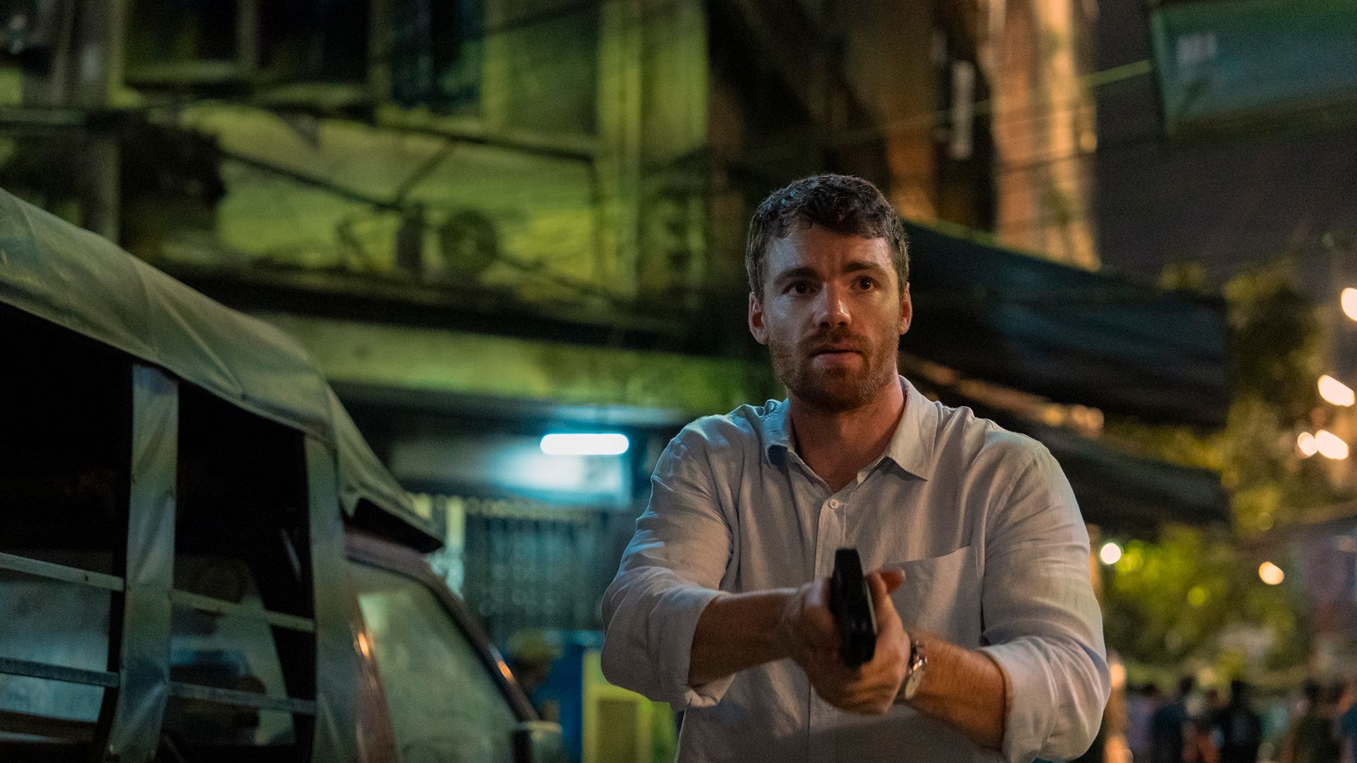 Peter holding a gun in The Night Agent