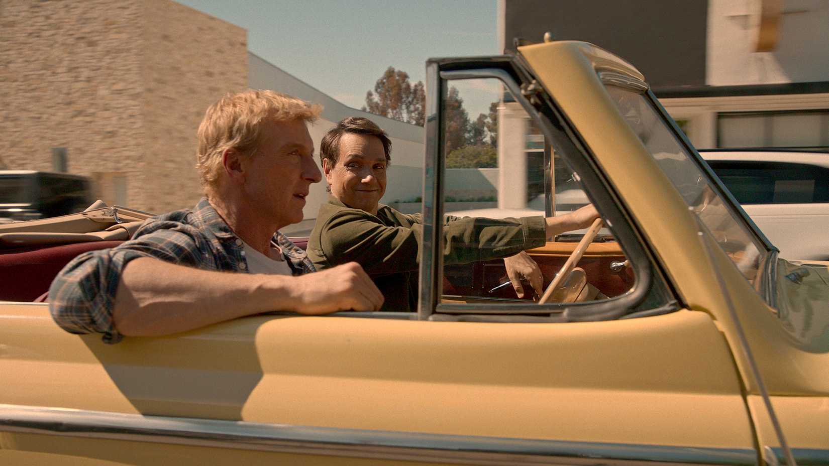 Johnny and Daniel driving in a car together in Cobra Kai