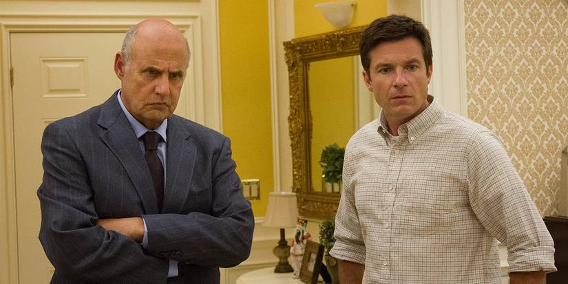 Michael Tambor as George Bluth Sr. and Jason Bateman as Michael Bluth looking confused as they stand in the penthouse in Arrested Development.