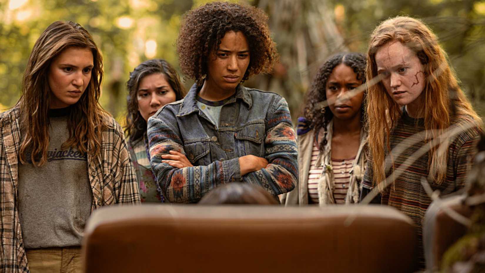 Teens in the wilderness stare at a chair in Yellowstone Season 3