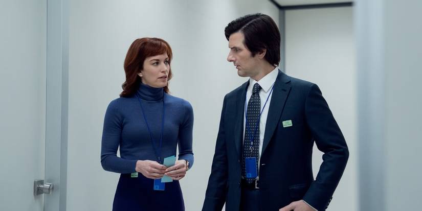 Helly and Mark walking down a white hallway in Severance