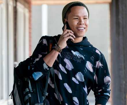 Bobby outside smiling while talking on the phone in Tracker.