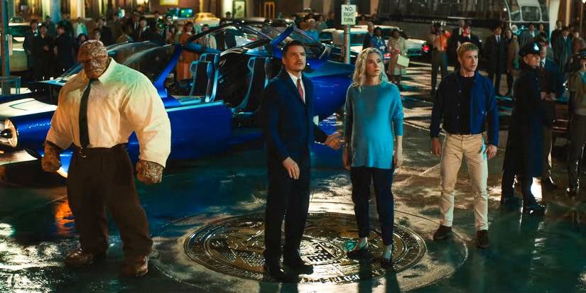 The main cast of The Fantastic Four: First Steps standing outside next to their car looking up