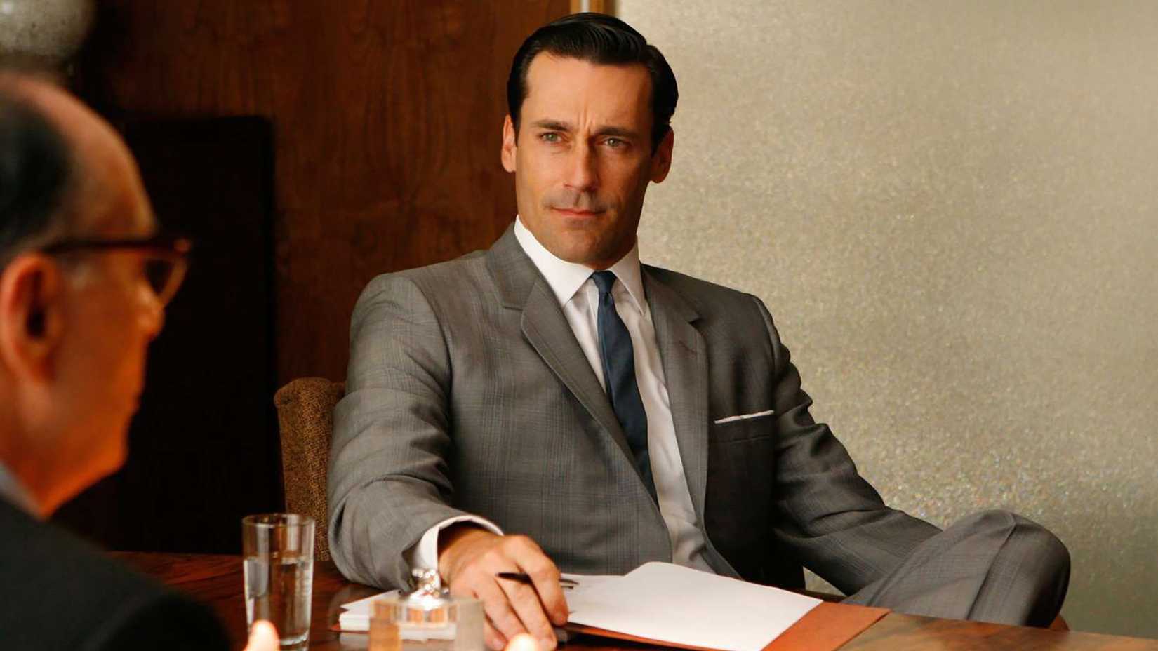 Don sitting in a meeting with a client in Mad Men