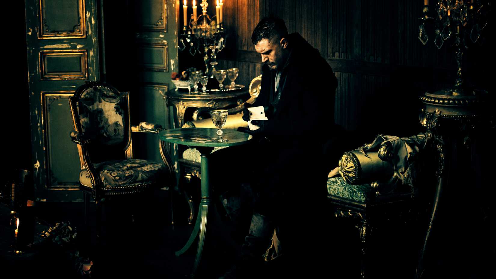 James reads cards at a table in Taboo