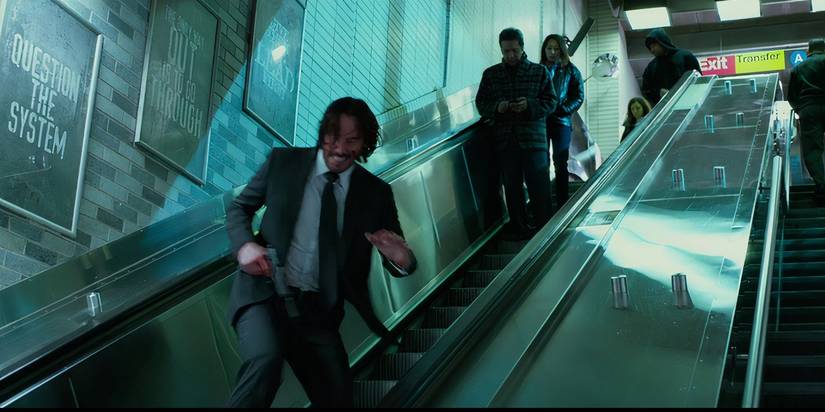 John Wick (Keanu Reeves) running through the subway tunnels in Chapter 2 subway scene