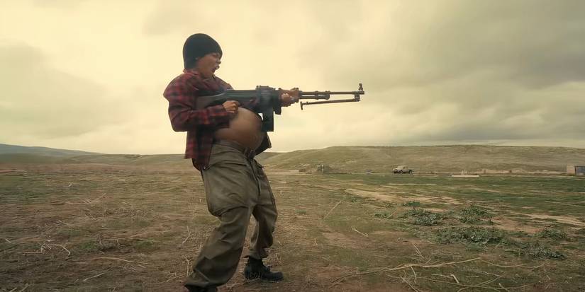 Teyana Taylor in One Battle After Another firing  large machine gun