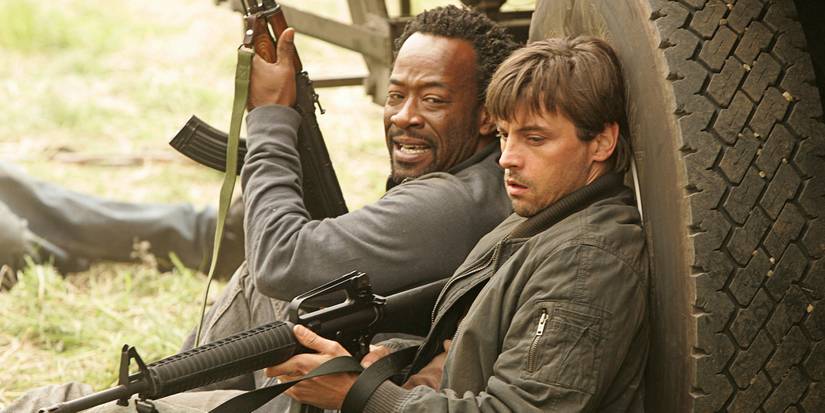 Skeet Ulrich and Lennie James in Jericho holding rifles and ducking for cover