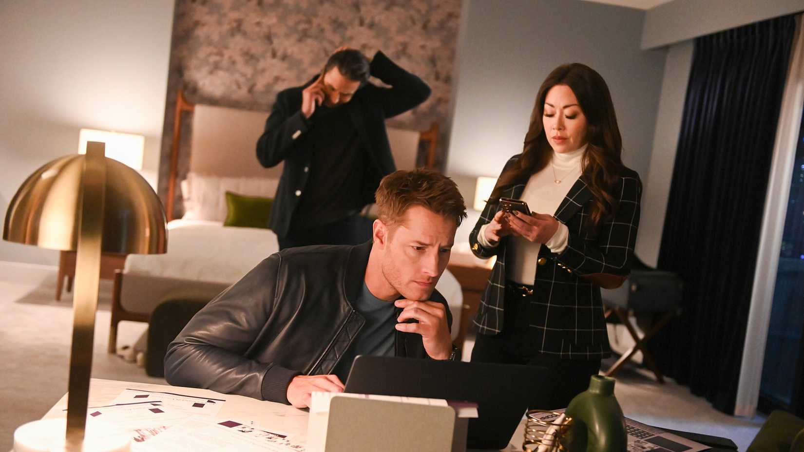 Colter on a computer with Reenie and Scharf on phones in the background in Tracker.