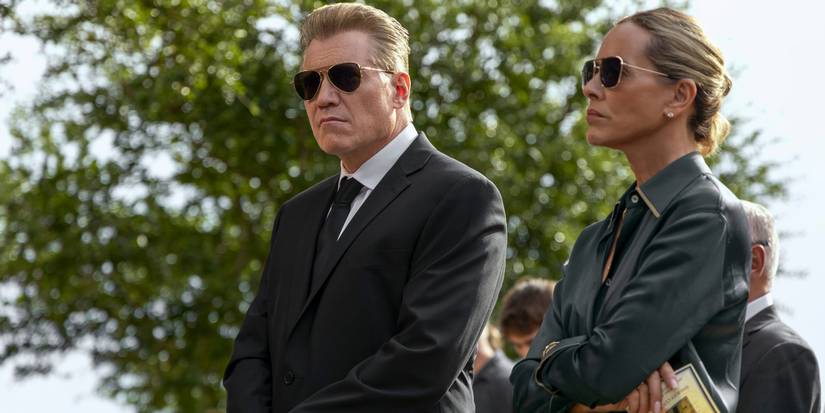 Holt McCallany and Maria Bello as Harlan and Mae Buckley attending a funeral in The Waterfront