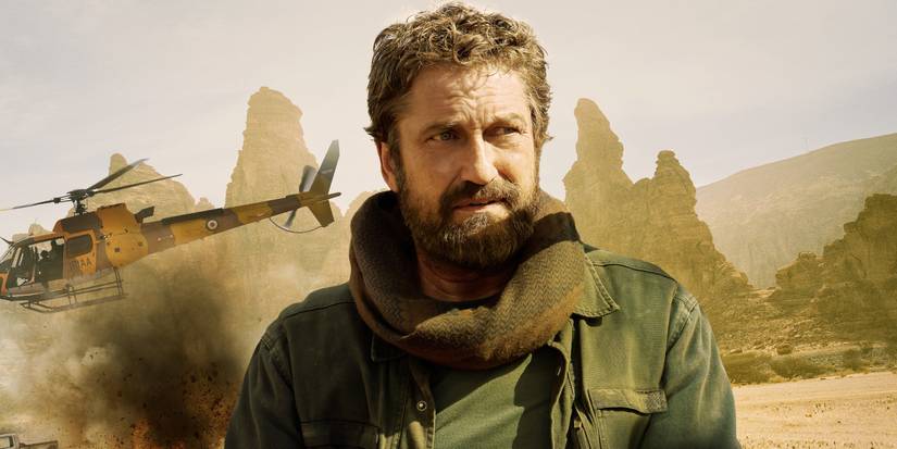 Gerard Butler stranded in the desert with a helicopter behind him in the movie Kandahar