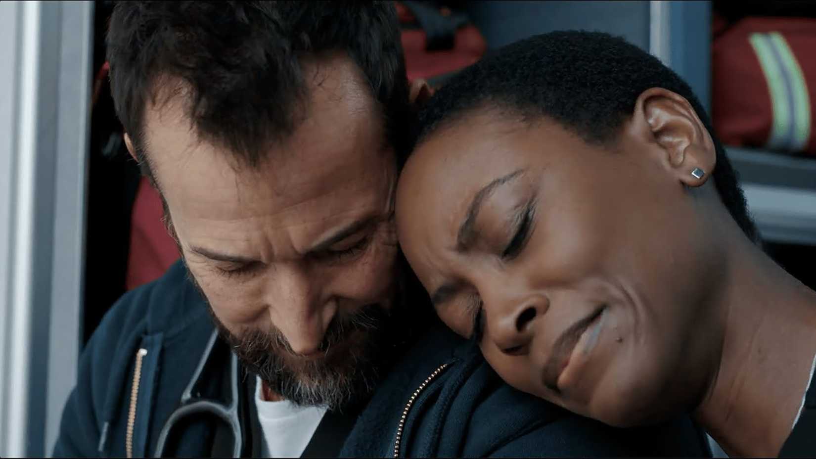 Dr. Collins resting her head on Dr. Robby's shoulder in The Pitt.