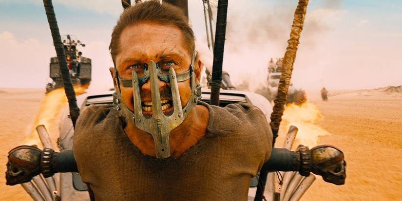 Tom Hardy in Mad Max: Fury Road strapped to the front of a car in the desert