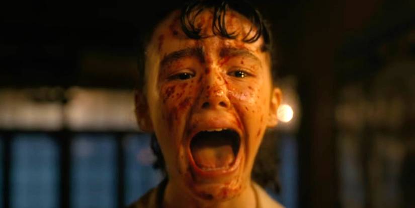 A person with blood on their face screaming in Welcome to Derry