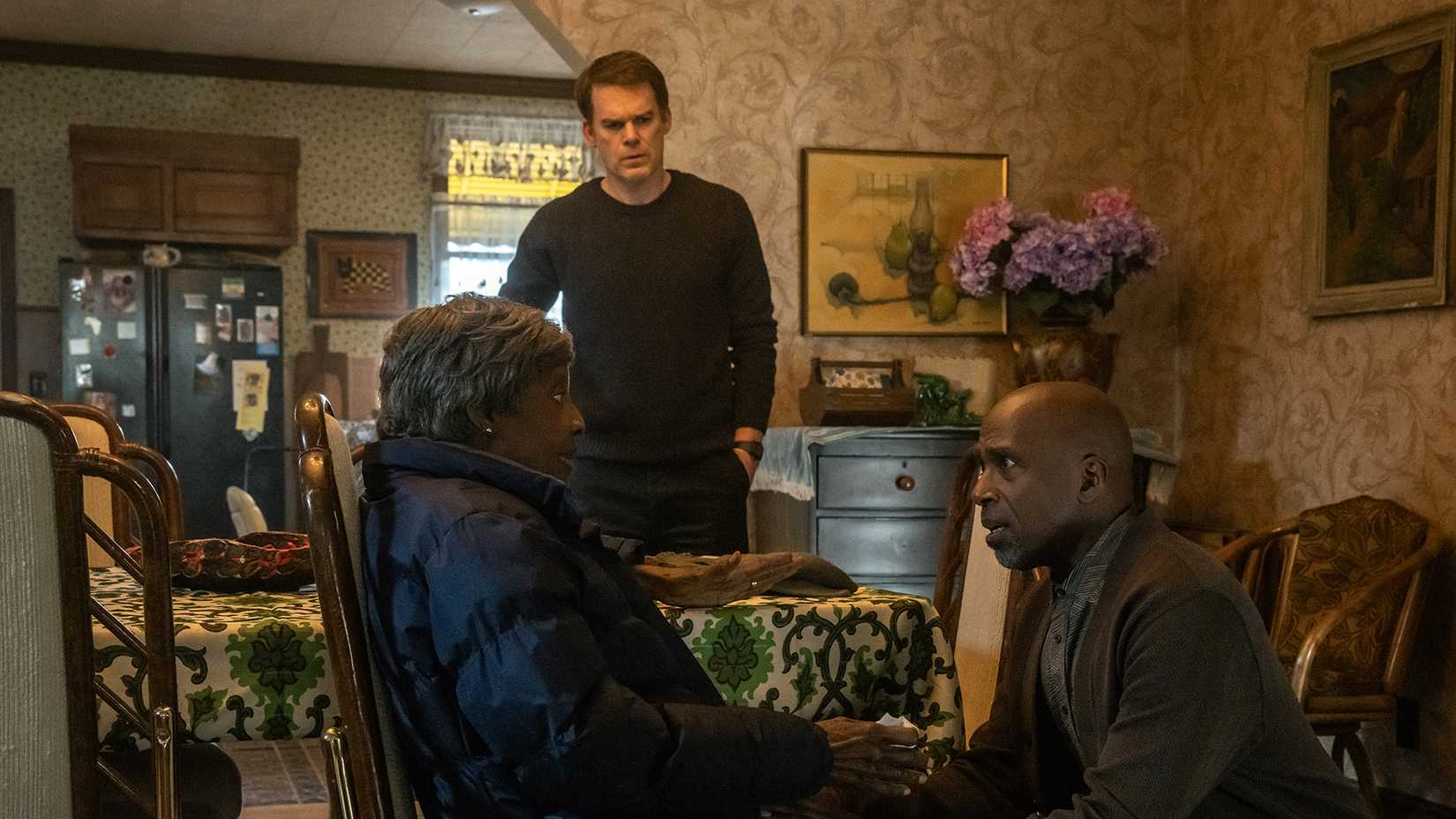 Blessing kneeling down talking to his mother as Dexter looks on in Dexter: Resurrection