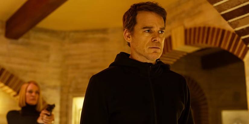 Dexter standing in Leon's museum, Charley behind him holding a gun in Dexter: Resurrection