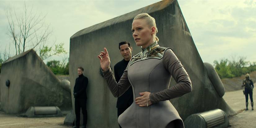 Laura Birn as Demerzel in Foundation standing outside raising her hand