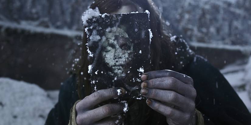 Jacob Elordi in Frankenstein holding a photo