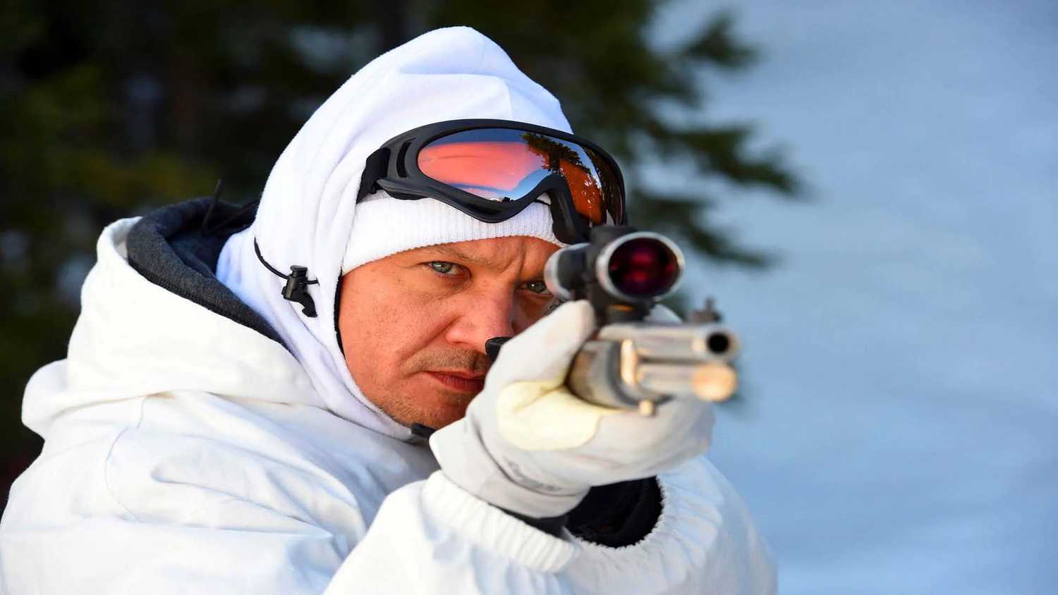 Jeremy Renner's character pointing a gun at the camera in Wind River