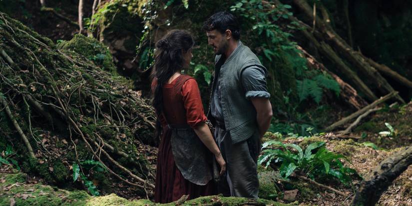 Jessie Buckley and Paul Mescal in Hamnet standing in the woods