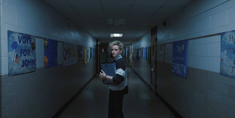 Julia Garner in Weapons standing in a school hallway